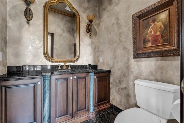 half bathroom with vanity, toilet, baseboards, and granite finish floor