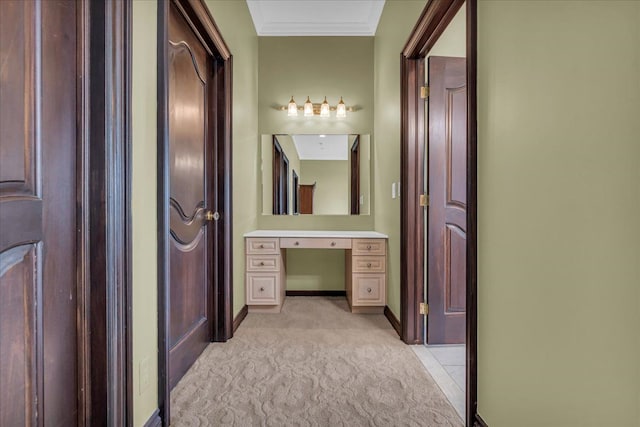 bathroom featuring crown molding, baseboards, and vanity