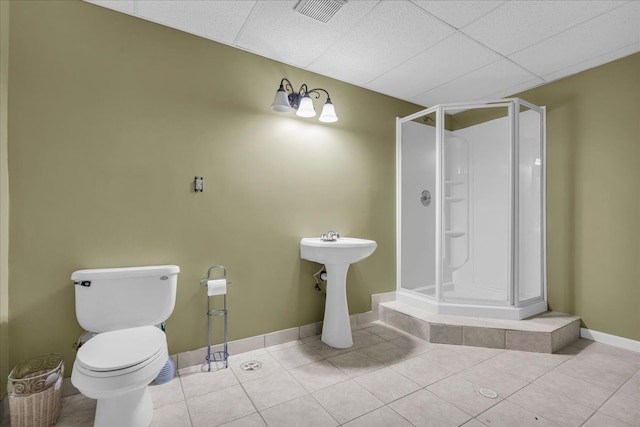 bathroom with toilet, a stall shower, visible vents, baseboards, and tile patterned flooring