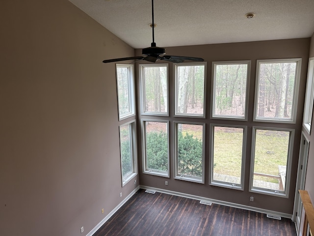 unfurnished dining area featuring visible vents, dark wood-style flooring, baseboards, and ceiling fan