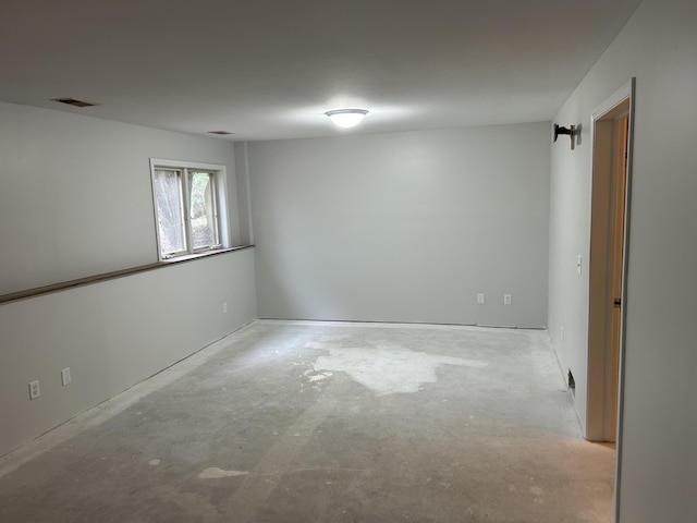 unfurnished room featuring concrete flooring and visible vents