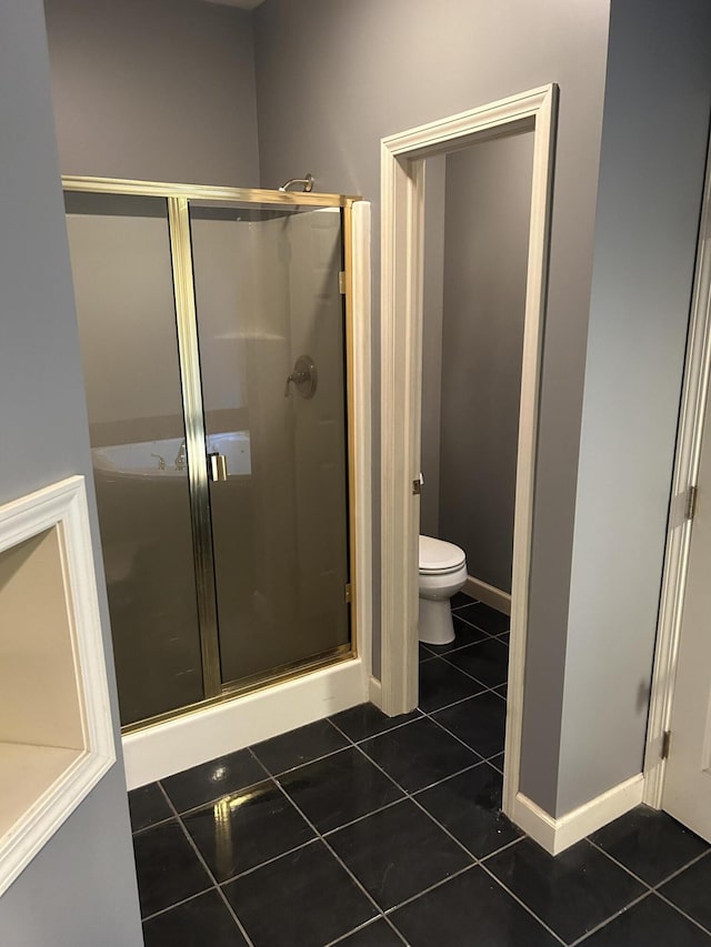 bathroom with tile patterned floors, toilet, baseboards, and a shower stall