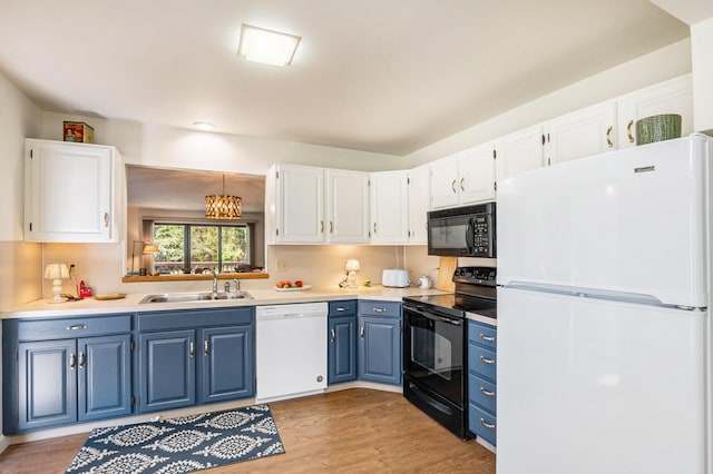 kitchen featuring light wood-style flooring, a sink, white cabinetry, black appliances, and blue cabinets
