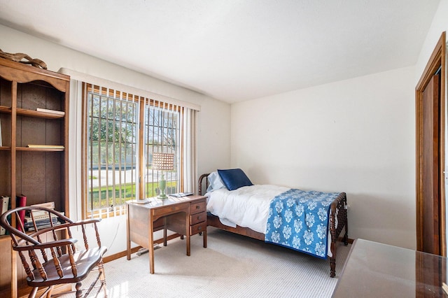 bedroom featuring light colored carpet