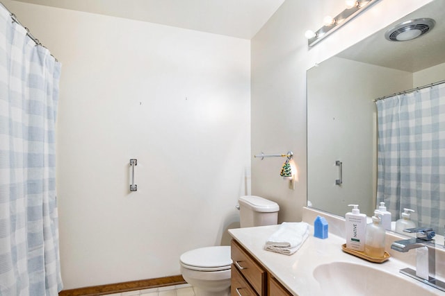 bathroom featuring tile patterned flooring, toilet, visible vents, and vanity