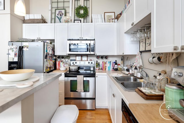 kitchen featuring light countertops, stainless steel appliances, and a sink