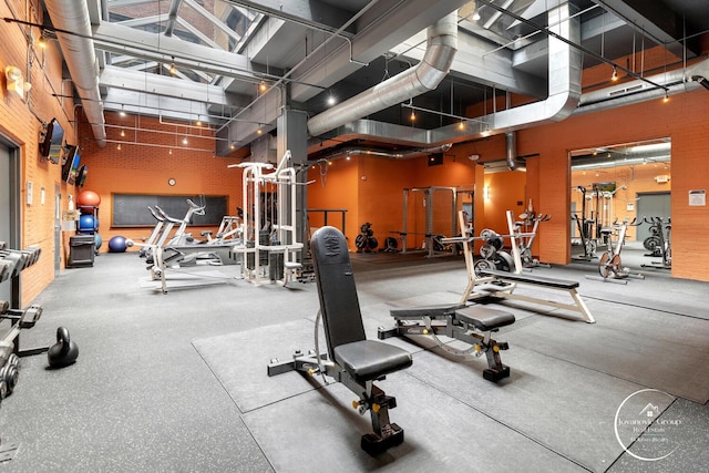 exercise room featuring a high ceiling