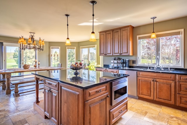 kitchen with plenty of natural light, stone tile flooring, and brown cabinets