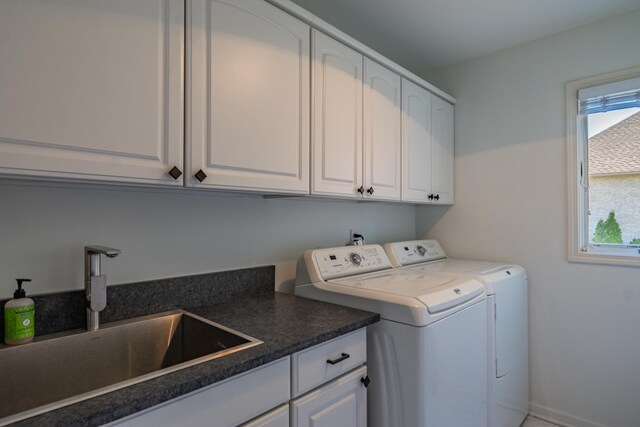 clothes washing area featuring cabinet space, independent washer and dryer, and healthy amount of natural light
