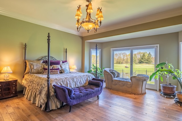 bedroom with access to outside, a chandelier, hardwood / wood-style floors, and crown molding