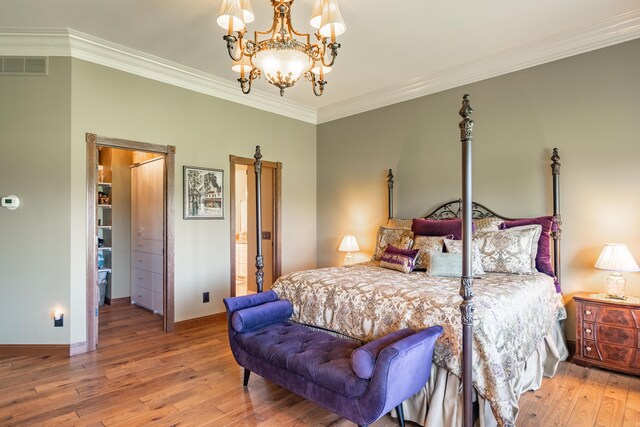 bedroom featuring hardwood / wood-style floors, crown molding, a chandelier, and baseboards