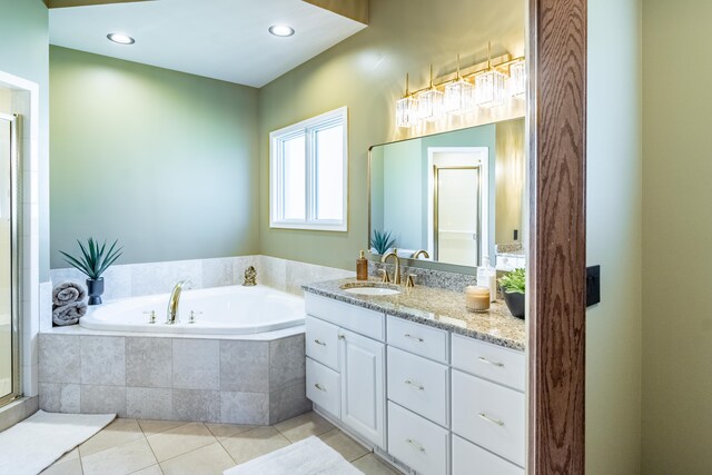 bathroom with tile patterned flooring, a garden tub, a stall shower, and vanity