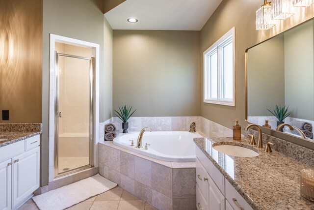bathroom featuring a shower stall, vanity, a bath, and tile patterned flooring