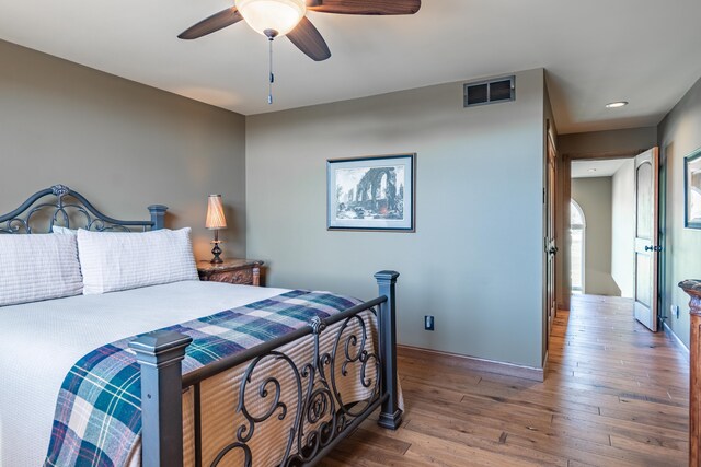 bedroom with wood finished floors, recessed lighting, and a ceiling fan
