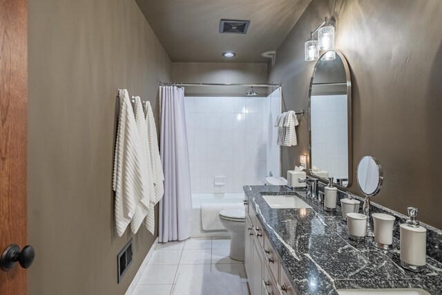 bathroom with tile patterned floors, toilet, double vanity, and shower / tub combo