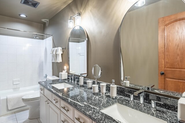 bathroom with toilet, tile patterned floors, shower / bathtub combination, and double vanity