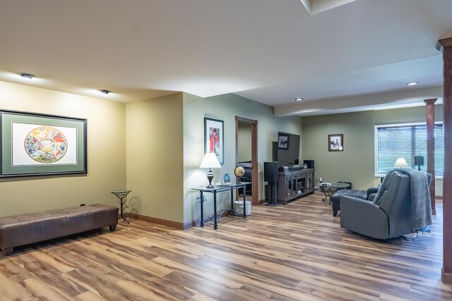living room with wood finished floors, baseboards, and recessed lighting