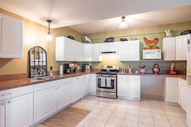 kitchen featuring white appliances, a sink, and white cabinetry