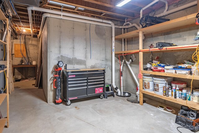unfinished below grade area featuring a workshop area