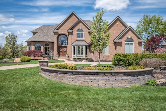 view of front of property featuring brick siding and a front lawn