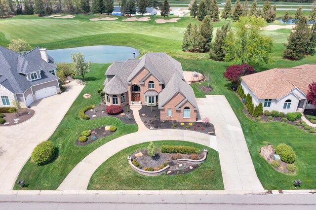view of subject property with a nearby body of water and a golf club