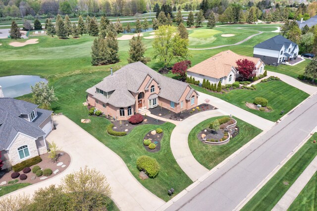 drone / aerial view of a large body of water and a golf course