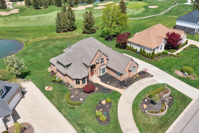 aerial view of a golf course and a nearby body of water
