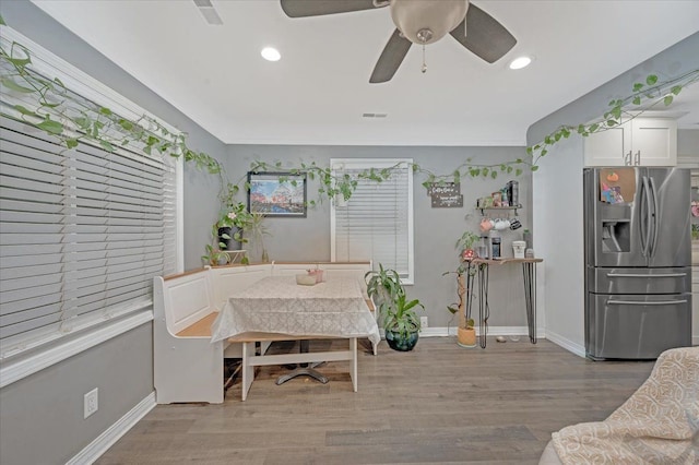 dining area featuring baseboards, light wood-type flooring, visible vents, and recessed lighting