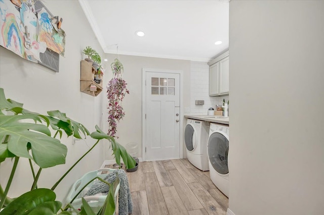 laundry area featuring washing machine and dryer, recessed lighting, light wood finished floors, crown molding, and cabinet space
