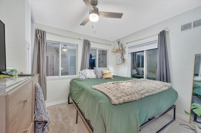 bedroom with a ceiling fan, light carpet, visible vents, and baseboards