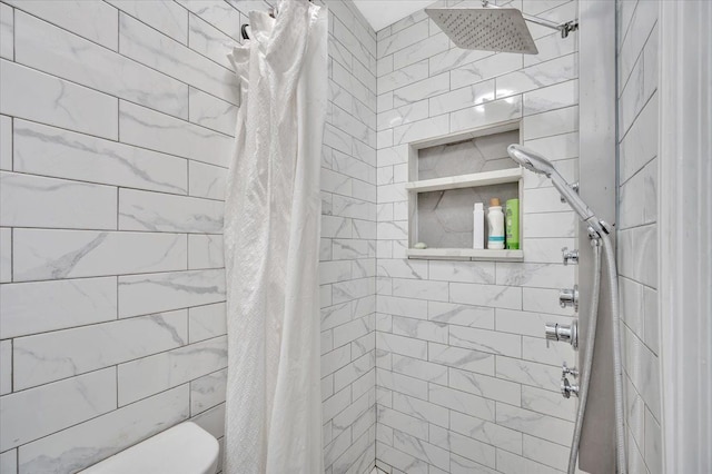 full bath featuring toilet and tiled shower