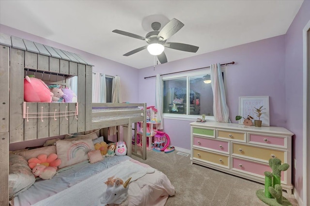 carpeted bedroom with baseboards, visible vents, and a ceiling fan