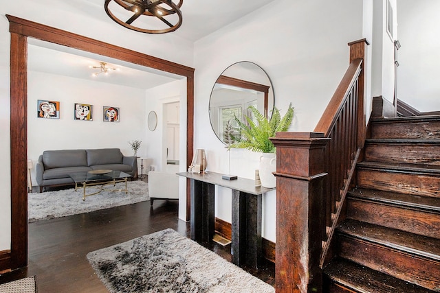 stairway with visible vents, wood finished floors, and baseboards
