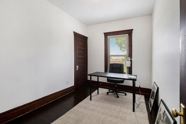 home office featuring baseboards and wood finished floors