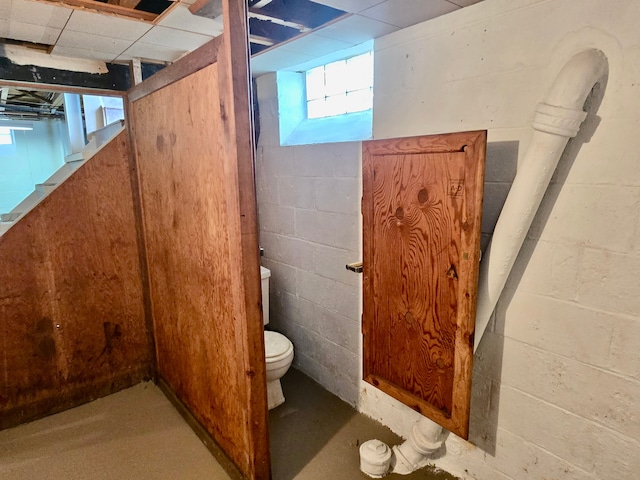 bathroom with concrete floors and toilet