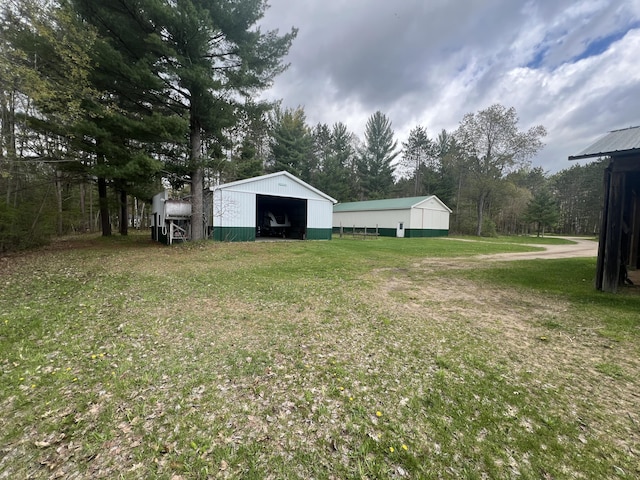 200 S Shearer Rd, Gladwin, MI 48624 - view of yard featuring an outbuilding, an outdoor structure, and a garage