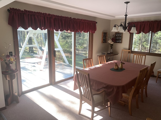 200 S Shearer Rd, Gladwin, MI 48624 - carpeted dining room with an inviting chandelier