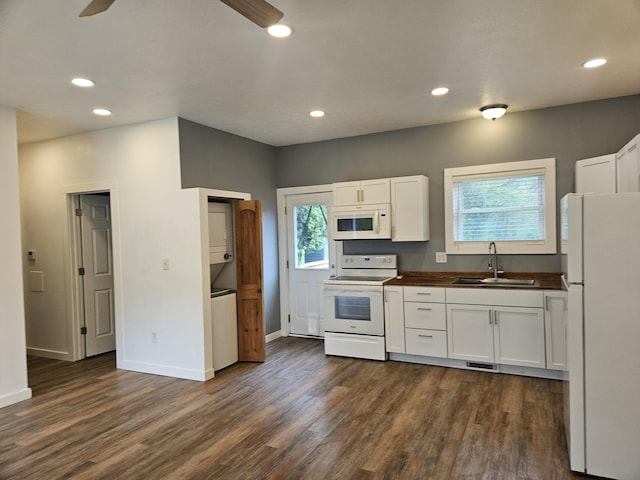 kitchen featuring a ceiling fan, white appliances, a sink, white cabinetry, and dark wood-type flooring