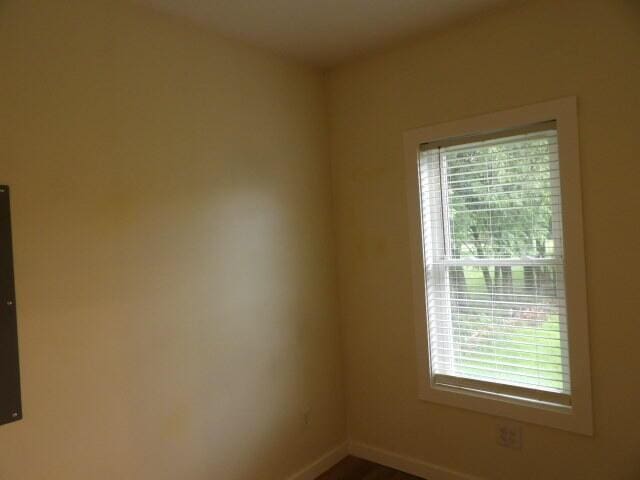 unfurnished room with baseboards