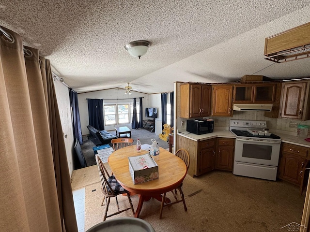 kitchen with lofted ceiling, under cabinet range hood, ceiling fan, white range with electric cooktop, and light countertops