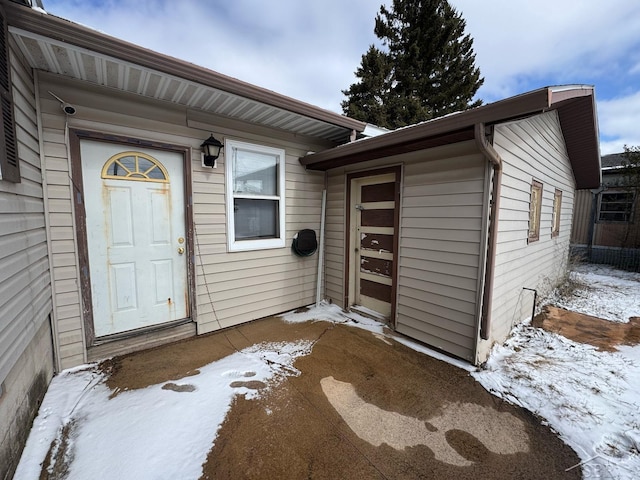 view of snow covered property entrance