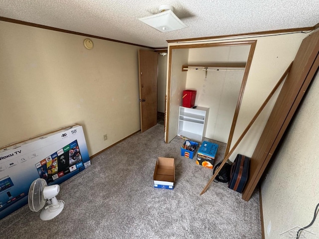 unfurnished bedroom featuring ornamental molding, a textured ceiling, carpet floors, and a closet