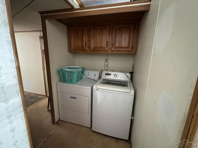 laundry area featuring washing machine and dryer and cabinet space