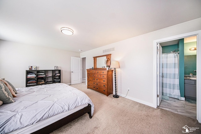 809 Sarah Ln, Milan, MI 48160 - bedroom featuring baseboards, ensuite bathroom, visible vents, and light colored carpet
