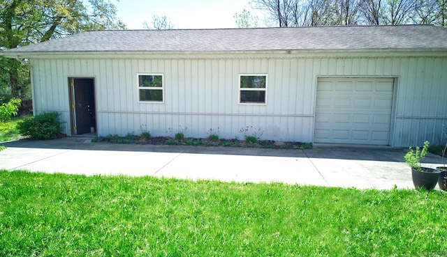 exterior space with concrete driveway and roof with shingles