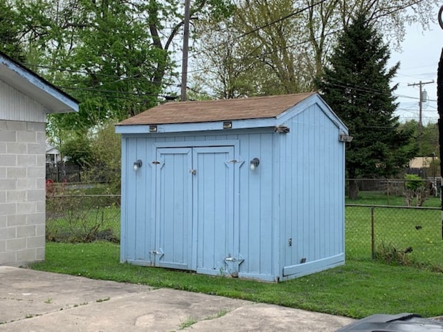 view of shed with fence