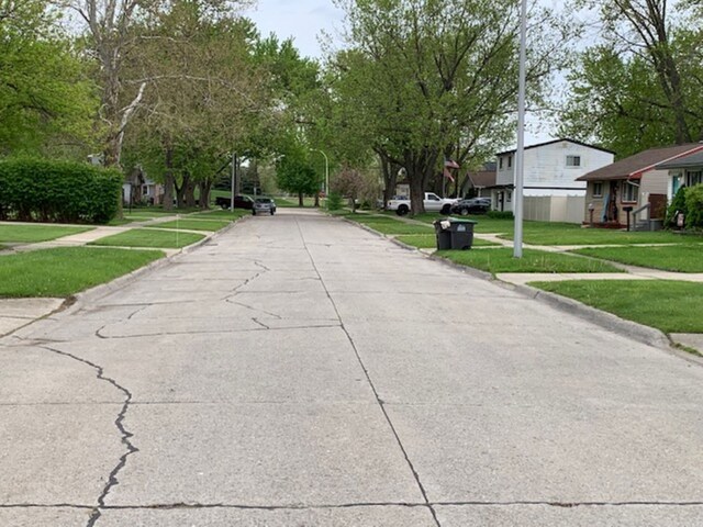 view of road with curbs and sidewalks