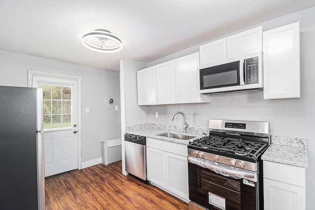 604 Montana Ave, Pontiac, MI 48341 - kitchen featuring stainless steel appliances, a sink, dark wood-style floors, and white cabinetry