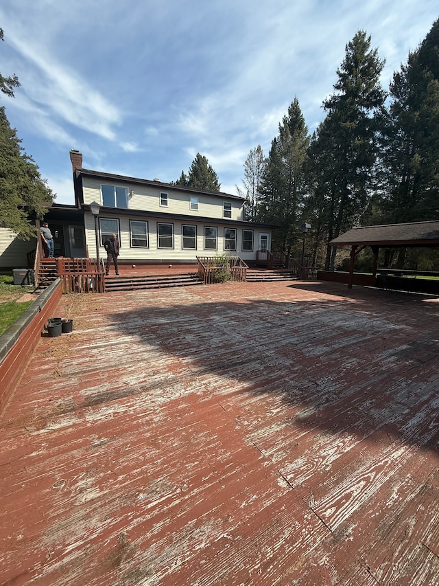 view of front of house with a chimney and a deck