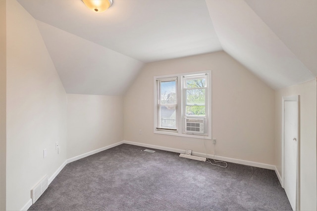 additional living space featuring carpet flooring, lofted ceiling, and baseboards